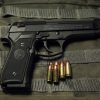 Beretta 92 FS 9mm Centerfire Pistol side profile on a neutral background with 9mm bullets on the side