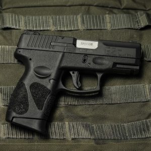 Taurus G2C 9mm semi-auto pistol side profile resting on a neutral background
