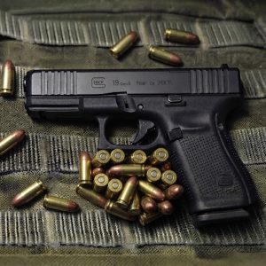 Glock 19 gen 5 on top of a military dress background