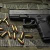 Glock 19 Gen 4 9mm semi-auto pistol side profile resting on a neutral background