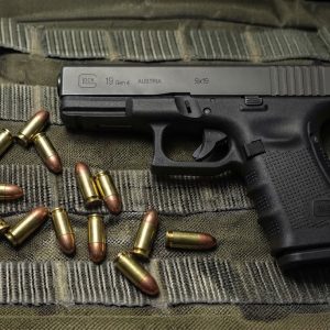Glock 19 Gen 4 9mm semi-auto pistol side profile resting on a neutral background