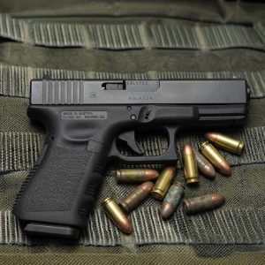 Glock 19 Gen 3 9mm semi-auto pistol side profile resting on a neutral background